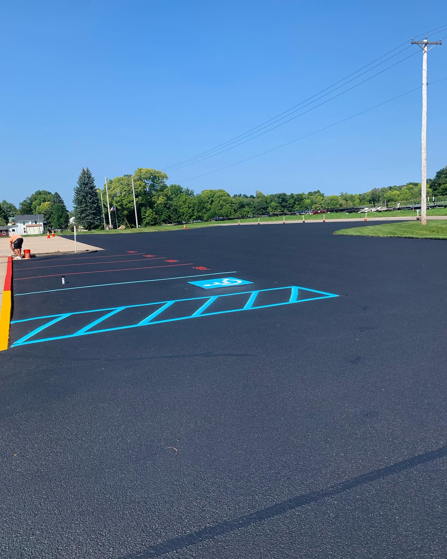 Sealcoating and line striping services: fresh asphalt with crisp, newly painted lines.